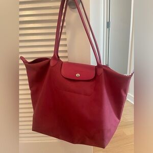 Used raspberry Longchamp Le Pliage bag